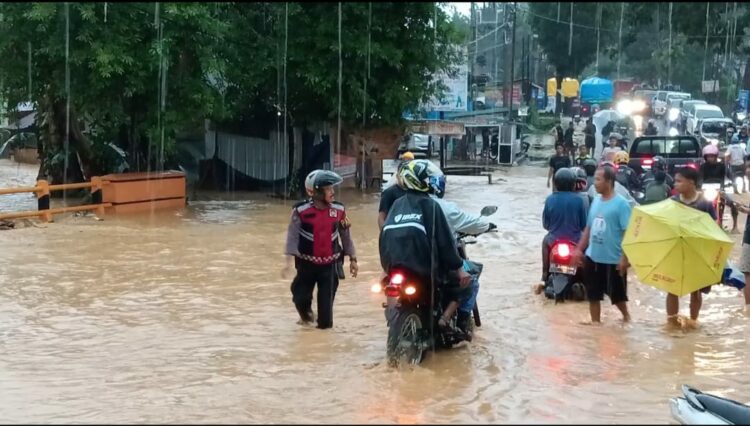 Personel Polresta Kendari saat bantu warga terdampak banjir